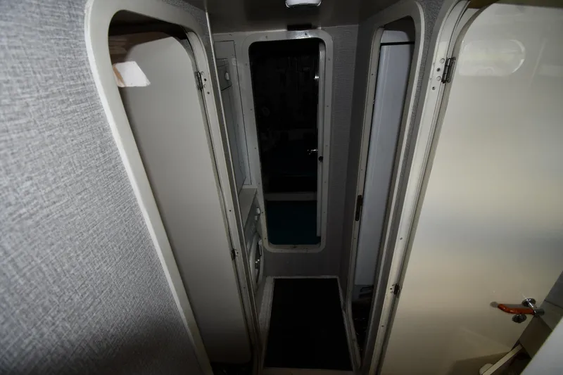 Slide: The Image of Narrow hallway inside 2001 Ferretti Yachts 72, featuring doors and textured walls. - 108