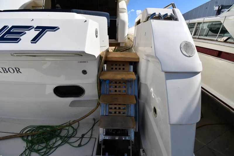 Slide: The Image of Rear view of 2001 Ferretti Yachts 72 with wooden steps and mooring ropes. - 11