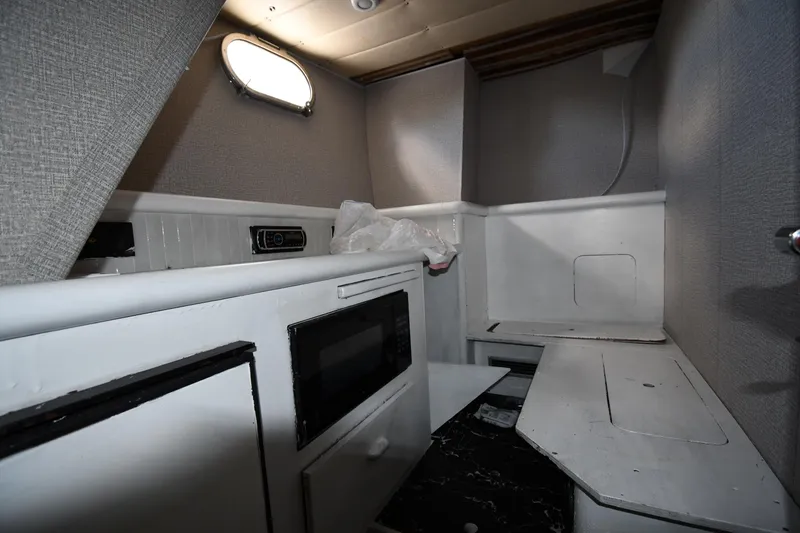 Slide: The Image of Interior of 2001 Ferretti Yachts 72, featuring compact kitchen area with microwave. - 110