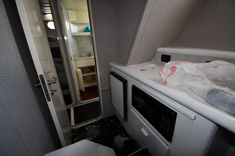 Slide: The Image of Interior of 2001 Ferretti Yachts 72, featuring a compact kitchen area with appliances. - 111