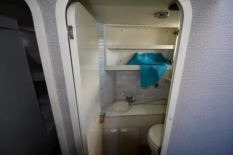 Slide: The Image of Compact bathroom in a 2001 Ferretti Yachts 72, featuring a sink and storage shelves. - 112