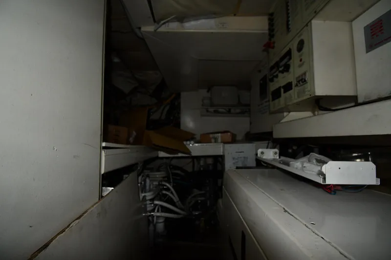 Slide: The Image of Engine room of a 2001 Ferretti Yachts 72, showcasing control panels and wiring. - 120