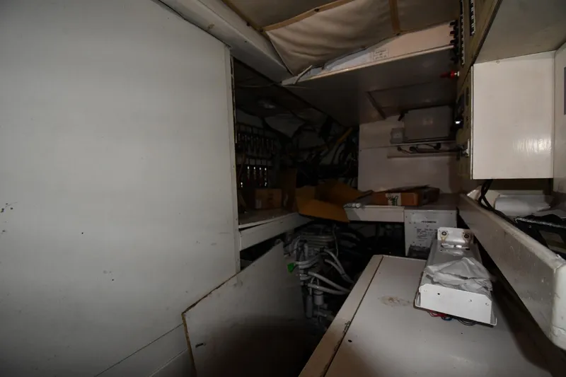 Slide: The Image of Engine room of a 2001 Ferretti Yachts 72, showcasing mechanical components and storage. - 121