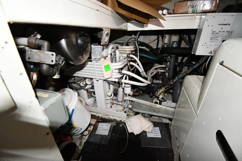 Slide: The Image of Engine room of a 2001 Ferretti Yachts 72, showcasing mechanical components and wiring. - 132