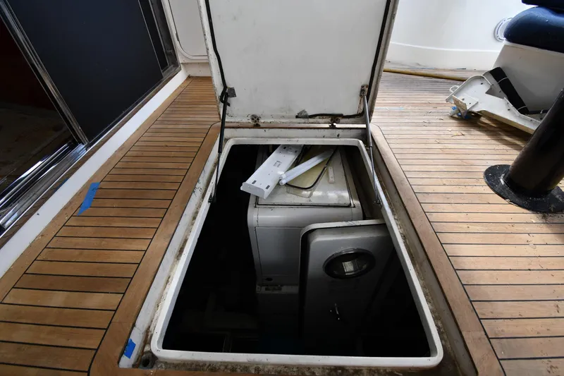 Slide: The Image of Open hatch on 2001 Ferretti Yachts 72, revealing interior storage space. - 133