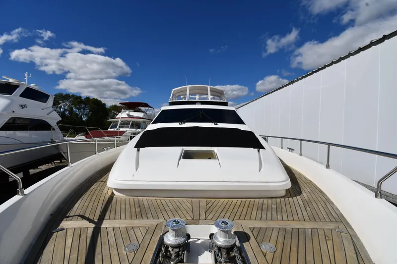 Slide: The Image of 2001 Ferretti Yachts 72 on deck, showcasing sleek design under a clear blue sky. - 15