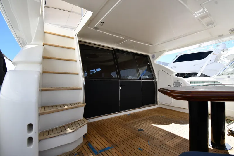 Slide: The Image of 2001 Ferretti Yachts 72 aft deck with wooden flooring and staircase. - 20