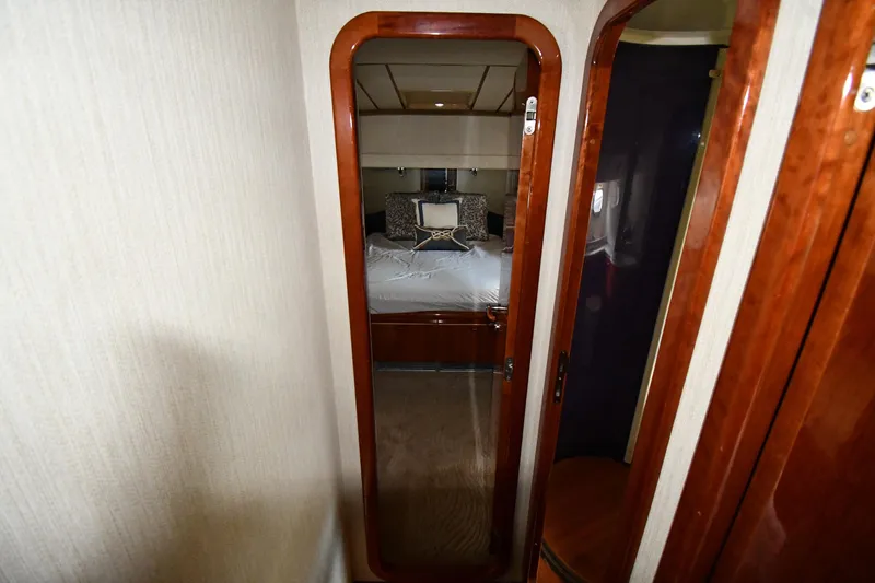 Slide: The Image of Luxurious bedroom interior of 2001 Ferretti Yachts 72, featuring elegant wood finishes. - 44