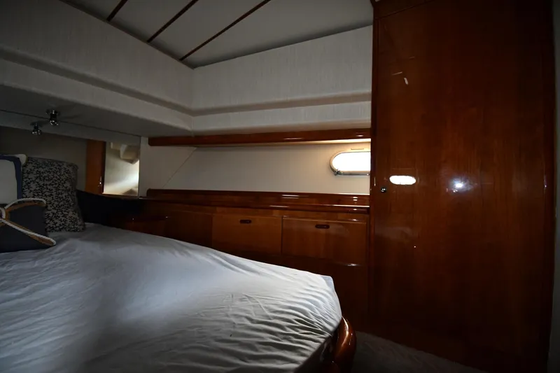 Slide: The Image of Luxurious cabin interior of 2001 Ferretti Yachts 72 with wooden finishes and cozy bedding. - 46