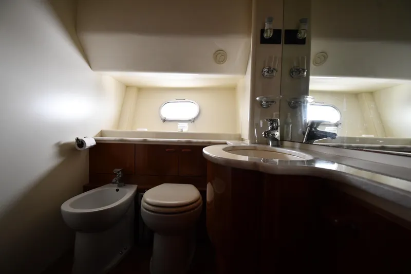 Slide: The Image of Bathroom interior of 2001 Ferretti Yachts 72, featuring toilet, bidet, and sink. - 52