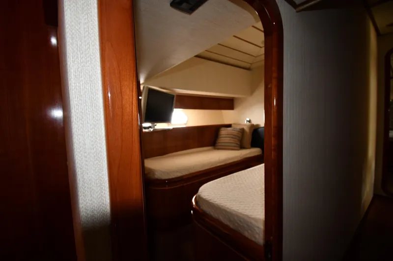 Slide: The Image of Interior cabin of 2001 Ferretti Yachts 72, featuring twin beds and a TV. - 61
