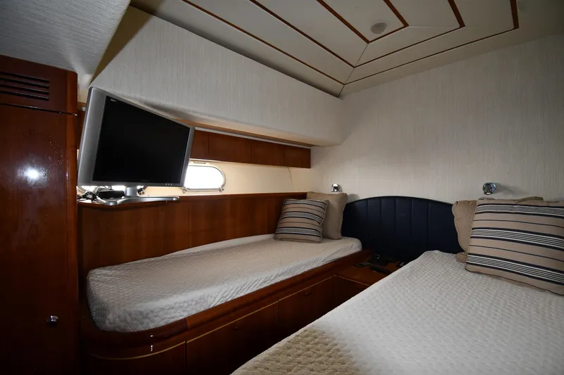 Slide: The Image of Twin cabin interior of 2001 Ferretti Yachts 72 with TV and striped pillows. - 62