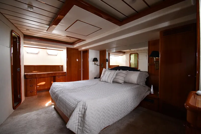 Slide: The Image of Luxurious bedroom interior of 2001 Ferretti Yachts 72, featuring elegant wood finishes. - 71