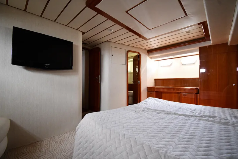 Slide: The Image of Luxurious bedroom interior of 2001 Ferretti Yachts 72, featuring elegant wood finishes and modern amenities. - 72