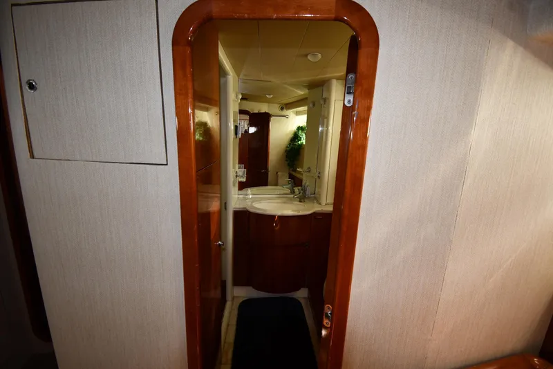 Slide: The Image of Bathroom interior of 2001 Ferretti Yachts 72, featuring wooden trim and modern fixtures. - 75