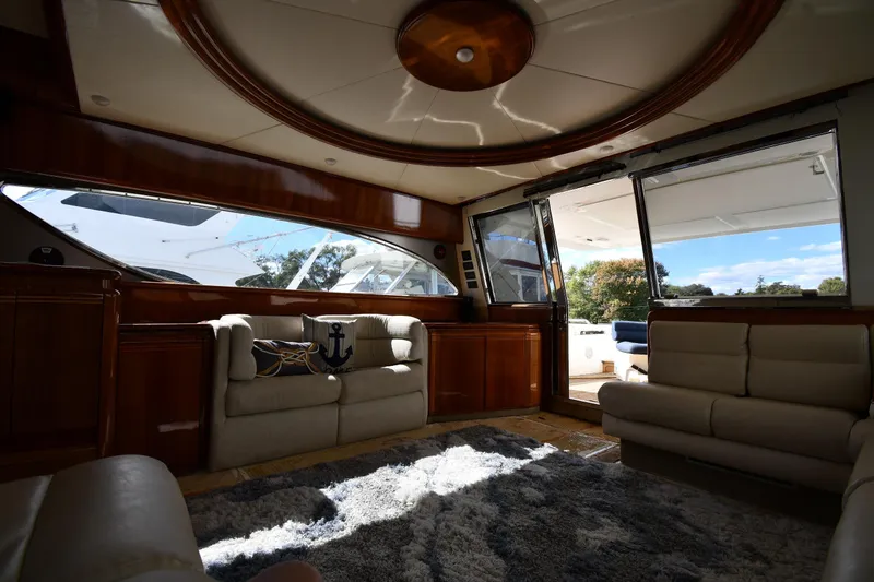 Slide: The Image of Luxurious interior of a 2001 Ferretti Yachts 72 with plush seating and elegant wood finishes. - 80