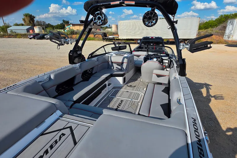 Slide: The Image of 2020 Moomba Makai boat interior with gray seating and advanced audio system. - 10
