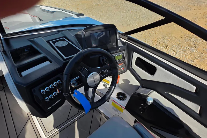 Slide: The Image of 2020 Moomba Makai boat dashboard with steering wheel and control panel. - 15