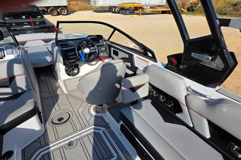 Slide: The Image of 2020 Moomba Makai boat interior with modern dashboard, steering wheel, and gray seating. - 16