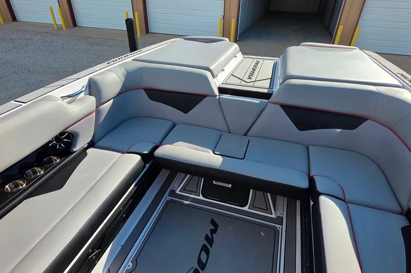 Slide: The Image of 2020 Moomba Makai boat interior with gray seating and cup holders. - 17