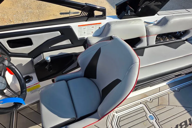 Slide: The Image of 2020 Moomba Makai boat interior with gray seating and steering wheel. - 18