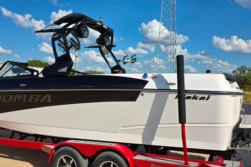 Slide: The Image of 2020 Moomba Makai boat on a red trailer under a blue sky. - 2