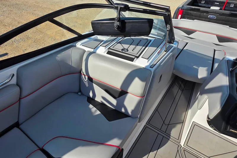 Slide: The Image of 2020 Moomba Makai boat interior with gray seating and red accents. - 20
