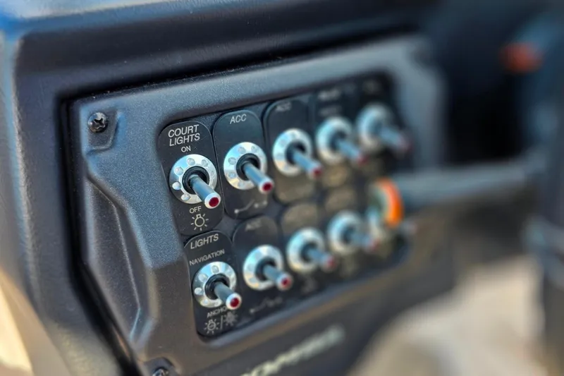 Slide: The Image of Control panel of a 2020 Moomba Makai boat with various switches. - 25