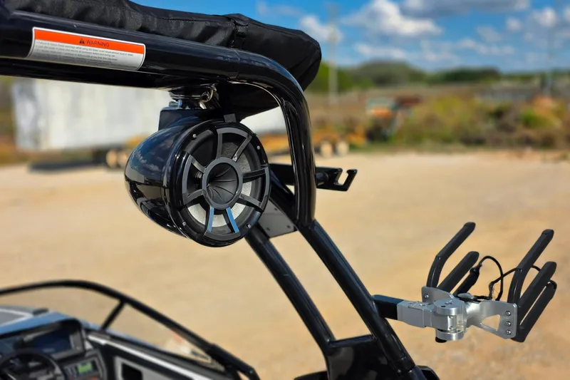 Slide: The Image of 2020 Moomba Makai boat with mounted speaker and wakeboard rack, outdoors. - 27