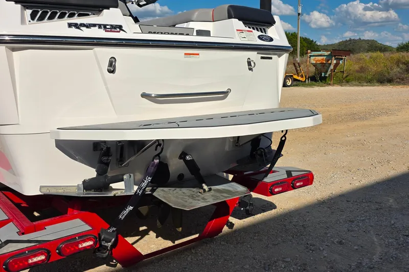 Slide: The Image of 2020 Moomba Makai boat rear view with Raptor Indmar engine, parked on a trailer. - 3