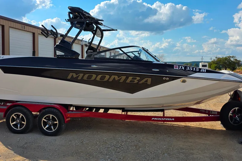 Slide: The Image of 2020 Moomba Makai boat on red trailer, parked outdoors under a blue sky. - 5