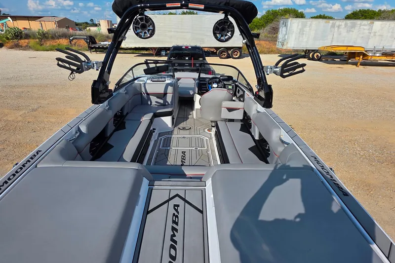 Slide: The Image of 2020 Moomba Makai boat interior with seating, speakers, and steering wheel in a sunny outdoor setting. - 8