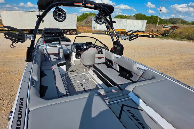 Slide: The Image of 2020 Moomba Makai boat interior with gray seating and advanced dashboard features. - 9