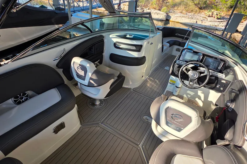 Slide: The Image of 2022 Crownline 255 SS SURF boat interior with modern dashboard and seating. - 13