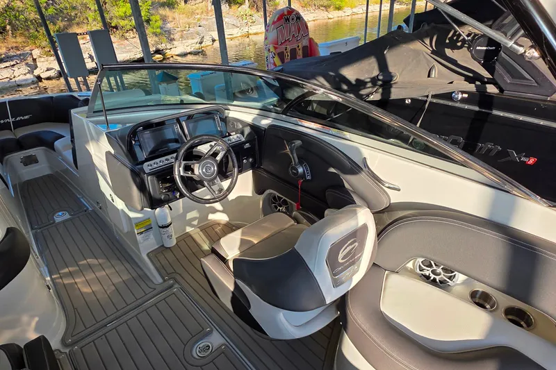 Slide: The Image of 2022 Crownline 255 SS SURF boat interior with modern dashboard and seating. - 15