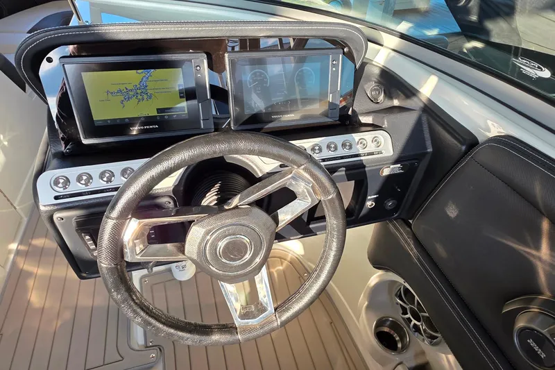 Slide: The Image of 2022 Crownline 255 SS SURF dashboard with steering wheel and dual display screens. - 18