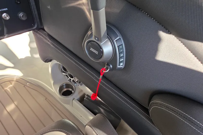 Slide: The Image of 2022 Crownline 255 SS SURF boat throttle control with red safety lanyard. - 19