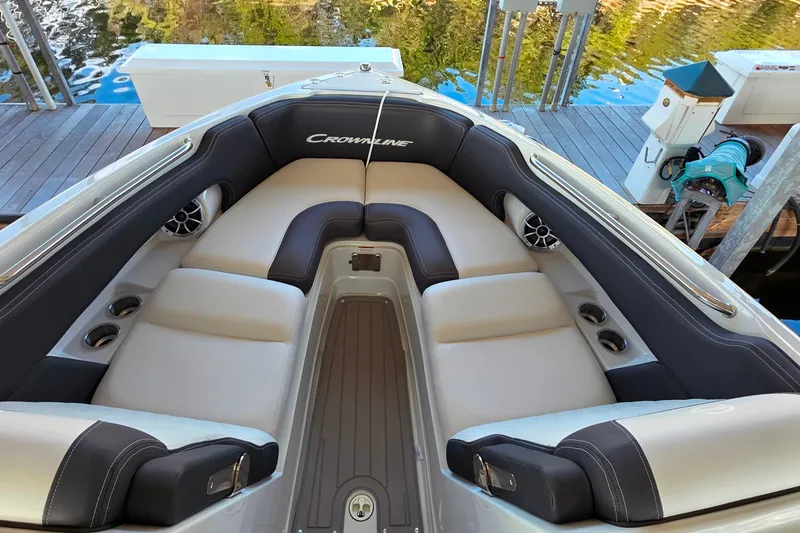 Slide: The Image of 2022 Crownline 255 SS SURF boat interior with cushioned seating and cup holders. - 20