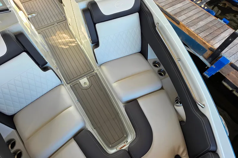 Slide: The Image of 2022 Crownline 255 SS SURF boat interior with cushioned seating and cup holders. - 22