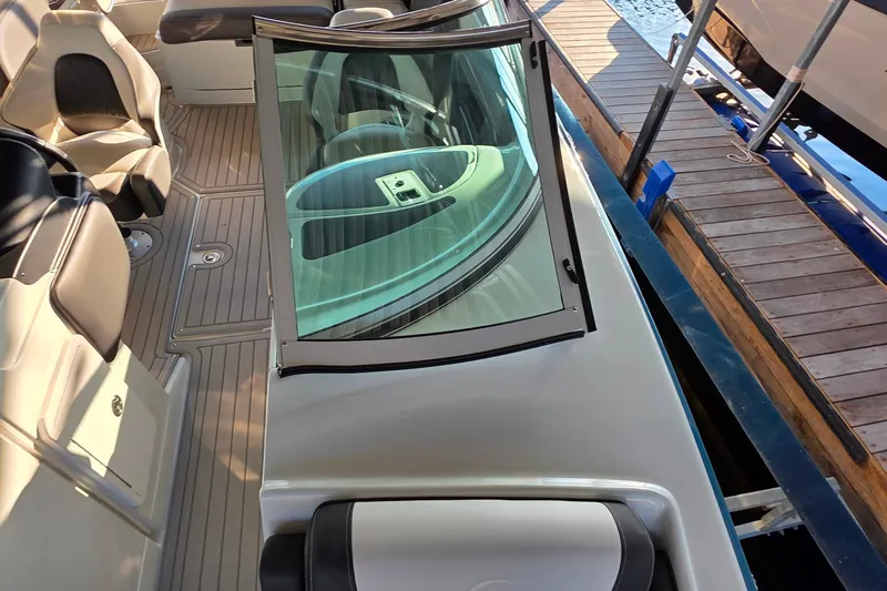Slide: The Image of 2022 Crownline 255 SS SURF boat interior with seating and dashboard view. - 25