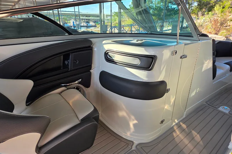 Slide: The Image of 2022 Crownline 255 SS SURF boat interior with sleek seating and modern dashboard design. - 27