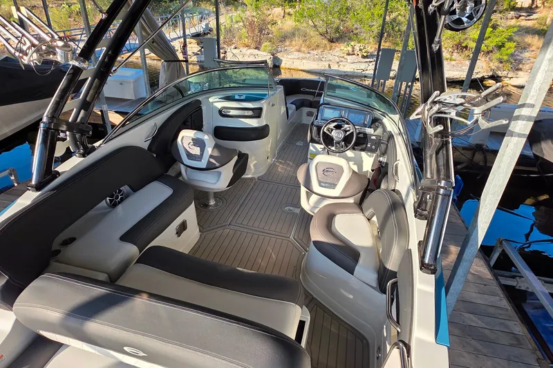 Slide: The Image of 2022 Crownline 255 SS SURF boat interior with modern seating and steering console. - 8