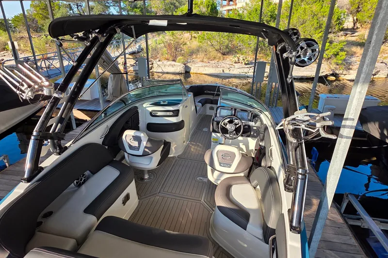 Slide: The Image of 2022 Crownline 255 SS SURF boat interior with sleek seating and modern dashboard. - 9