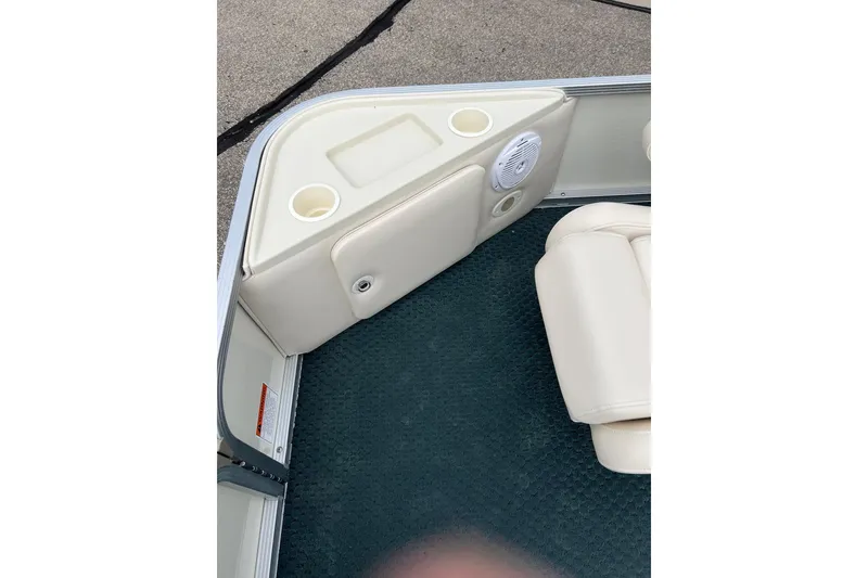 Slide: The Image of Interior of a 2006 Bennington 2575 FS boat with cup holders and speaker. - 13