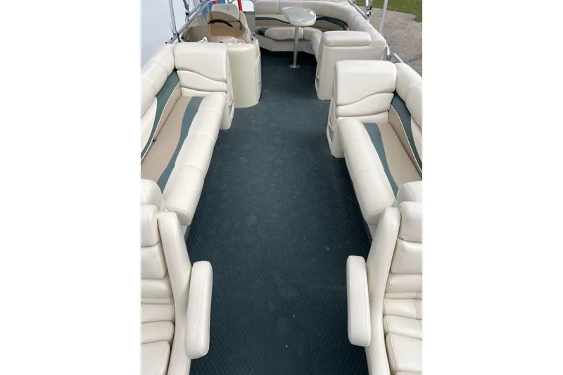 Slide: The Image of 2006 Bennington 2575 FS boat interior with beige seating and blue carpet. - 14