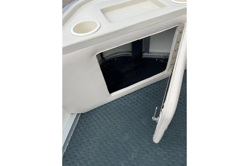 Slide: The Image of Open storage compartment on 2006 Bennington 2575 FS boat with cup holder. - 15