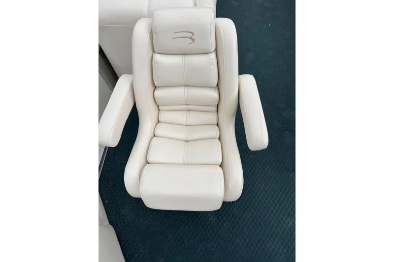 Slide: The Image of Luxurious white captain's chair from a 2006 Bennington 2575 FS boat. - 17
