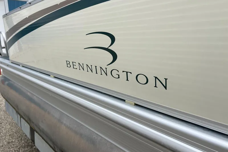 Slide: The Image of 2006 Bennington 2575 FS boat side view with logo and sleek design. - 3