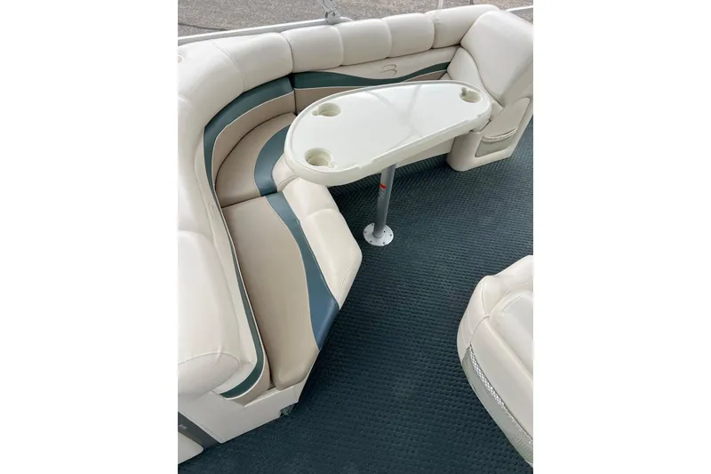 Slide: The Image of 2006 Bennington 2575 FS boat interior with cushioned seating and table. - 34