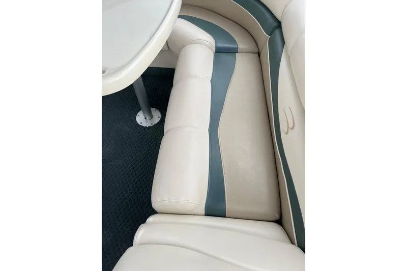 Slide: The Image of 2006 Bennington 2575 FS boat interior with beige and teal seating. - 36